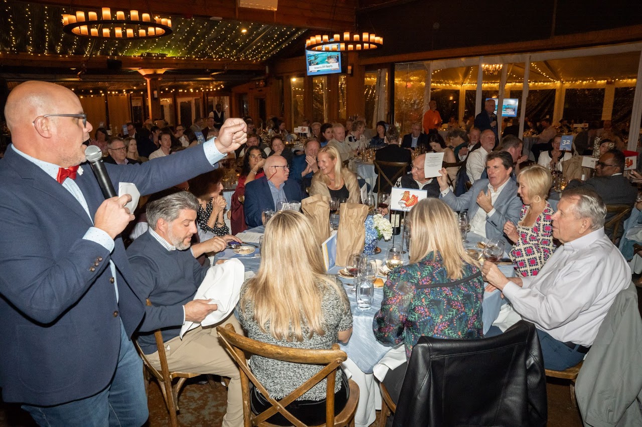 A packed room raising paddles